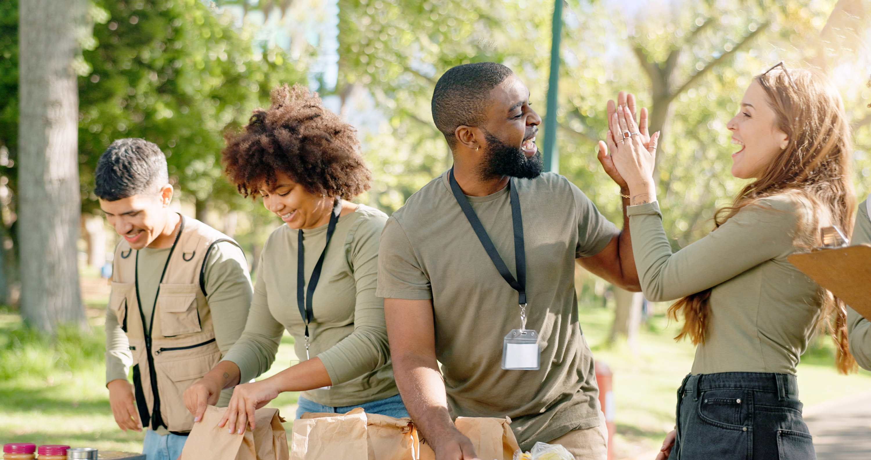 Volunteers standing and high fiving. 