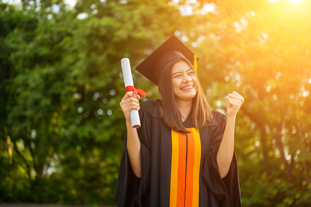 Girl with cap and gown on smiling. 
