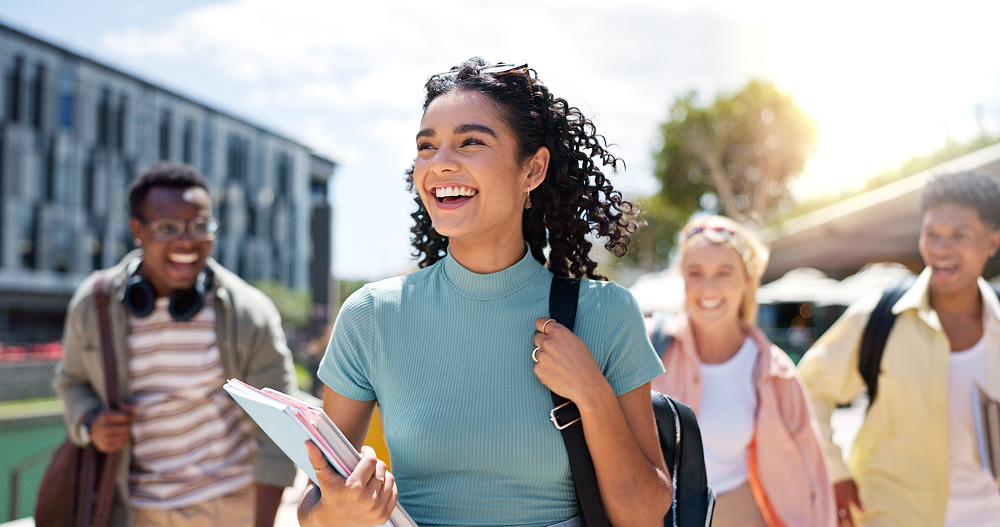 Woman with backpack on walking on campus. 